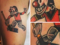 Татуировка хоккеиста с клюшкой на руке